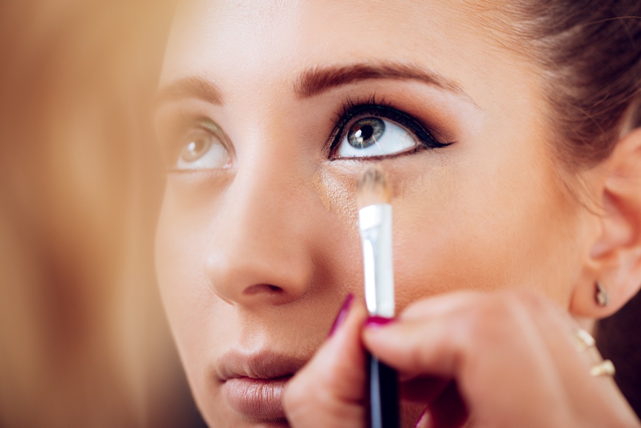 Concealer brush used by a Make-up artist on uner-eye area